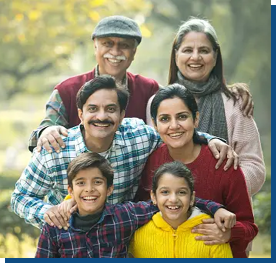 A family posing for the camera in front of trees.